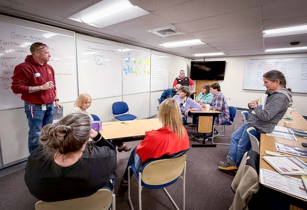 A photograph of EMS professionals gathered in a group in a classroom